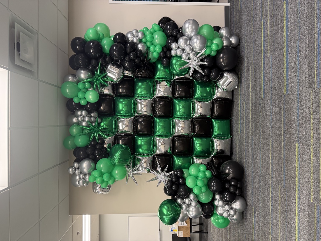 Green and black balloon backdrop wall